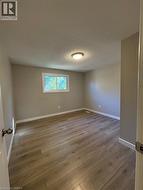 Spare room with light wood-type flooring and a textured ceiling - 