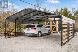 20'X24' CARPORT WITH STORAGE TRAILER BEHIND - 