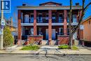 Brick facade featuring a columned porch with second-story balconies - 254 Emerald Street N Unit# Upper, Hamilton, ON  - Outdoor With Facade 