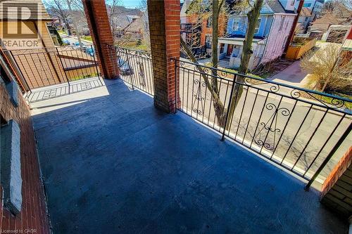 Balcony featuring a concrete surface, decorative wrought iron railing, and brick columns - 254 Emerald Street N Unit# Upper, Hamilton, ON - Outdoor