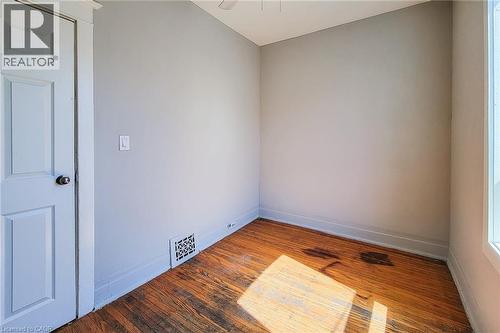 Interior space featuring wood-finish flooring, light gray walls, and white trim - 254 Emerald Street N Unit# Upper, Hamilton, ON - Indoor Photo Showing Other Room