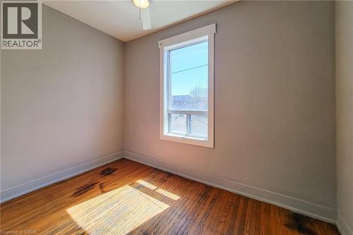 Room featuring wood-finish flooring, neutral wall paint, and white trim - 254 Emerald Street N Unit# Upper, Hamilton, ON - Indoor Photo Showing Other Room