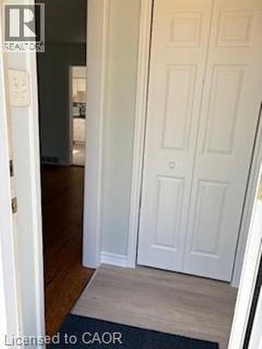 Entryway featuring light wood-finish flooring, white bi-fold closet doors, and wood flooring extending into the interior - 648 Francis Road, Burlington, ON - Indoor Photo Showing Other Room