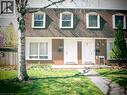 Brick facade townhome with a dark shingle roof, featuring white-framed windows and twin entry doors - 648 Francis Road, Burlington, ON  - Outdoor 