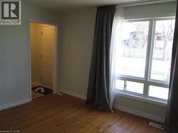 Warm wood-finish flooring complements light wall tones - 