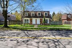 Brick and siding exterior featuring two white entry doors - 