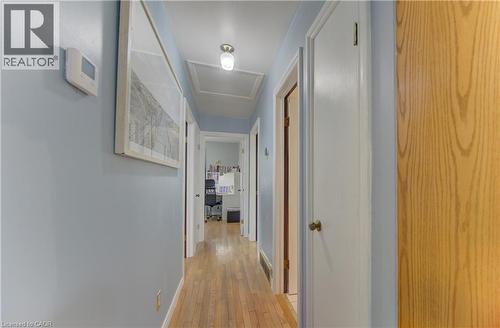 Hallway featuring wood-finish flooring, white trim, and a ceiling-mounted light fixture - 170 Martinglen Crescent, Kitchener, ON - Indoor Photo Showing Other Room