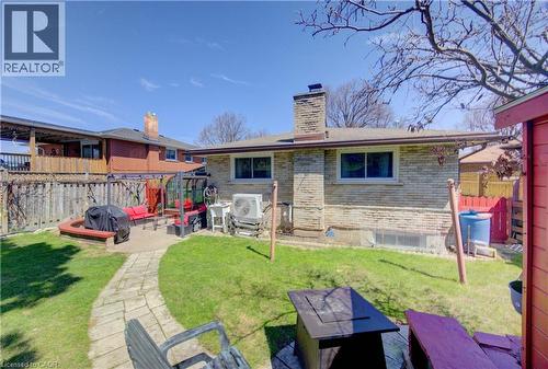 Expansive backyard featuring a stone patio, a natural stone-look pathway, and a large grassy area - 170 Martinglen Crescent, Kitchener, ON - Outdoor