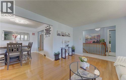 Light wood-finish flooring extends through the main living area - 170 Martinglen Crescent, Kitchener, ON - Indoor Photo Showing Living Room