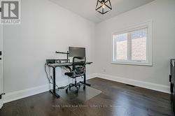 Second Bedroom With Wide Plank Hardwood Flooring - 