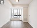 Spacious interior featuring wood-finish flooring, a contemporary ceiling light fixture, and a large sliding glass door opening to an outdoor balcony - 4878 Powers Common Unit# 1108, Burlington, ON  - Indoor Photo Showing Other Room 