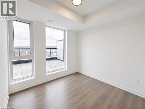 Room featuring wood-finish flooring and white baseboards - 4878 Powers Common Unit# 1108, Burlington, ON - Indoor Photo Showing Other Room