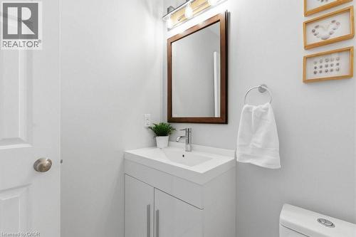 White vanity with integrated sink, chrome faucet, and storage cabinetry - 44 Lorilee Crescent, Kitchener, ON - Indoor Photo Showing Bathroom