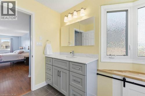 Bathroom vanity with a white countertop and undermount sink, gray cabinetry, and brushed nickel hardware - 44 Lorilee Crescent, Kitchener, ON - Indoor Photo Showing Bathroom