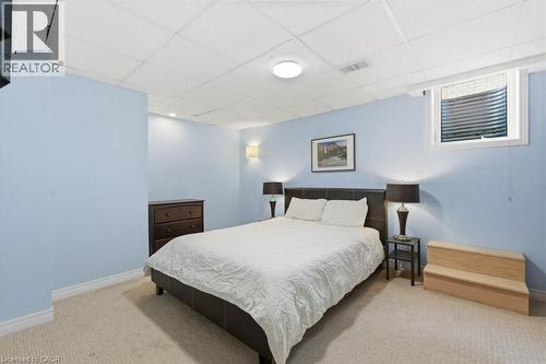 Carpeted room featuring a drop ceiling with recessed lighting and a single window with a window well - 44 Lorilee Crescent, Kitchener, ON - Indoor Photo Showing Bedroom