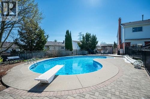 In-ground swimming pool featuring a diving board and concrete surround - 44 Lorilee Crescent, Kitchener, ON - Outdoor With In Ground Pool