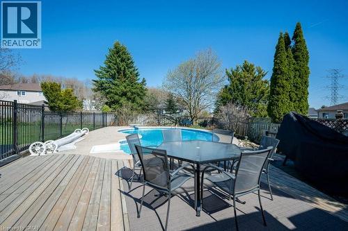 Spacious backyard featuring a multi-level wood deck, an irregular-shaped inground pool, and mature perimeter trees - 44 Lorilee Crescent, Kitchener, ON - Outdoor With Deck Patio Veranda