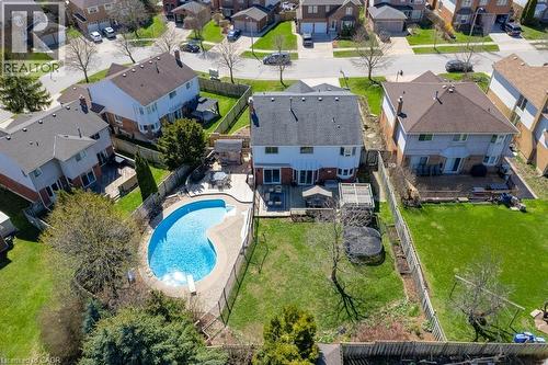 Rear exterior featuring a freeform swimming pool with surrounding hardscaping, a multi-level deck, and a fenced backyard - 44 Lorilee Crescent, Kitchener, ON - Outdoor With In Ground Pool With View