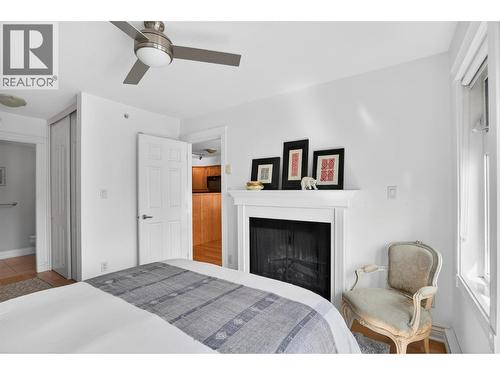 550 Rainbow Drive Unit# 302, Kaslo, BC - Indoor Photo Showing Bedroom With Fireplace