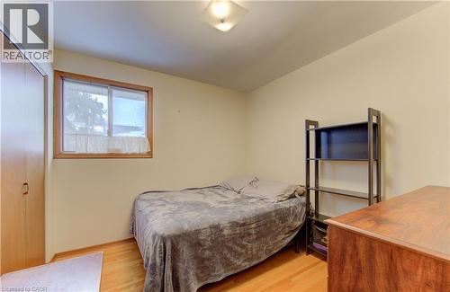 Room with wood-finish flooring, a wood-framed window, and light-toned walls - 98 Shea Crescent, Kitchener, ON - Indoor Photo Showing Bedroom