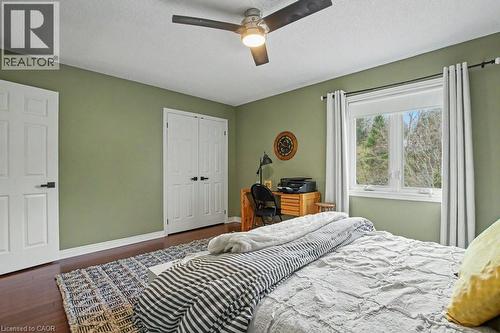 Spacious room with wood-finish flooring, a ceiling fan, and a large window - 2324 Homer Drive, Burlington, ON - Indoor Photo Showing Bedroom