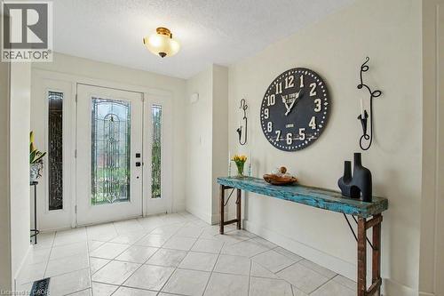 Entryway featuring a white door with decorative glass inserts, flanked by sidelight windows - 2324 Homer Drive, Burlington, ON - Indoor Photo Showing Living Room