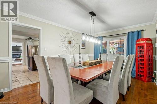 Formal dining area featuring hardwood flooring, crown molding, and wainscoting - 2324 Homer Drive, Burlington, ON - Indoor Photo Showing Dining Room