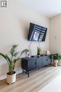 Light wood-finish flooring complements the neutral wall color - 