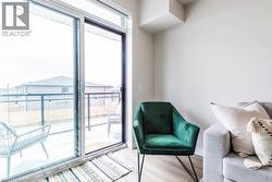 Sliding glass door opening to a private balcony with glass panel railings - 