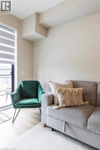 Light wood-finish flooring with a neutral wall palette - 120 Springvalley Crescent Unit# 208, Hamilton, ON - Indoor Photo Showing Living Room