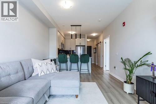 Open-concept living area featuring light wood-finish flooring - 120 Springvalley Crescent Unit# 208, Hamilton, ON - Indoor Photo Showing Living Room