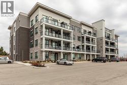 Contemporary multi-story building featuring a blend of dark brick, light stone veneer, and light-toned siding - 