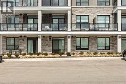Contemporary multi-story building featuring stone veneer and dark brick facade accents - 