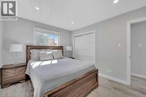 Recessed ceiling lighting illuminates a room with light gray walls and light wood-finish flooring - 168 Silver Aspen Crescent, Kitchener, ON - Indoor Photo Showing Bedroom
