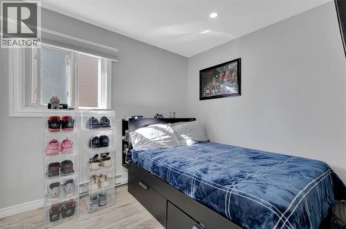 Bedroom featuring light wood-finish flooring, a single window with blinds, and recessed lighting - 168 Silver Aspen Crescent, Kitchener, ON - Indoor Photo Showing Bedroom