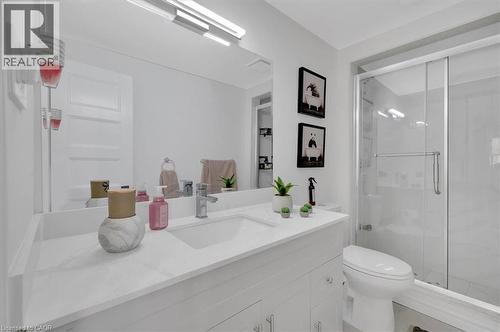 Bathroom featuring a white vanity with an integrated sink, polished chrome faucet, and a large wall-mounted mirror - 168 Silver Aspen Crescent, Kitchener, ON - Indoor Photo Showing Bathroom