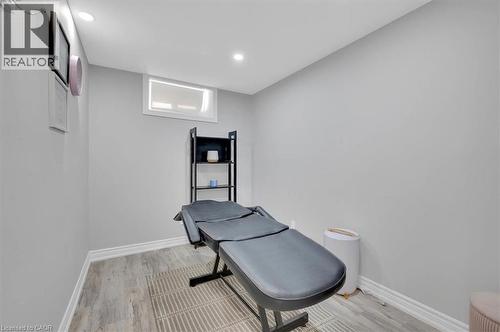 Light gray wall paint, wood-finish flooring, white baseboards, and a white-framed window - 168 Silver Aspen Crescent, Kitchener, ON - Indoor Photo Showing Other Room