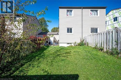 Expansive backyard featuring a sloped lawn and full privacy fencing - 168 Silver Aspen Crescent, Kitchener, ON - Outdoor