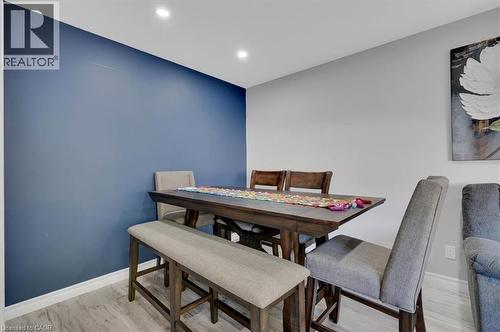 Dining area featuring a deep blue accent wall and recessed lighting - 168 Silver Aspen Crescent, Kitchener, ON - Indoor Photo Showing Dining Room