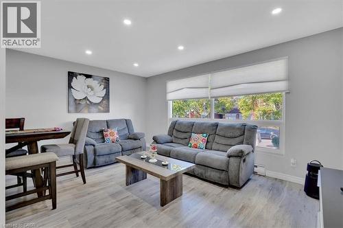 Open-concept living area featuring light wood-finish flooring, recessed lighting, and large windows with roller shades - 168 Silver Aspen Crescent, Kitchener, ON - Indoor Photo Showing Living Room