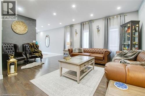 Living room with an accent wall, wood finished floors, and recessed lighting - 49 Scots Pine Trail, Kitchener, ON - Indoor Photo Showing Living Room
