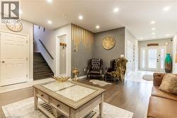 Living room with stairway, wood finished floors, and recessed lighting - 