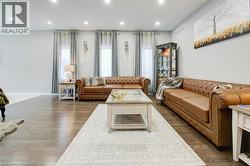 Living room with dark wood-style floors and recessed lighting - 