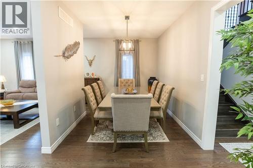 Dining area featuring dark wood-style floors and plenty of natural light - 49 Scots Pine Trail, Kitchener, ON - Indoor Photo Showing Dining Room