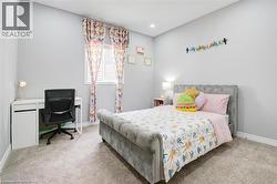 Bedroom featuring carpet flooring, an office area, and recessed lighting - 