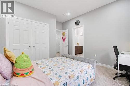 Carpeted bedroom featuring a desk and a closet - 49 Scots Pine Trail, Kitchener, ON - Indoor Photo Showing Bedroom
