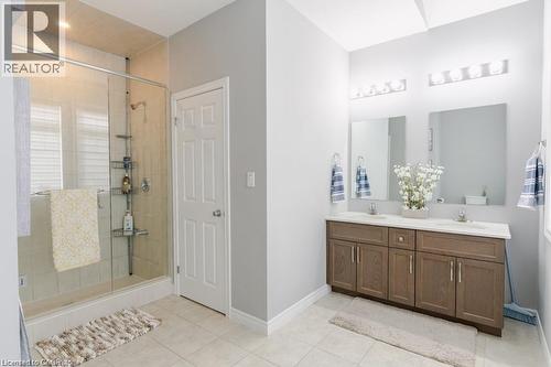 Full bathroom featuring double vanity, light tile patterned floors, and a stall shower - 49 Scots Pine Trail, Kitchener, ON - Indoor Photo Showing Bathroom