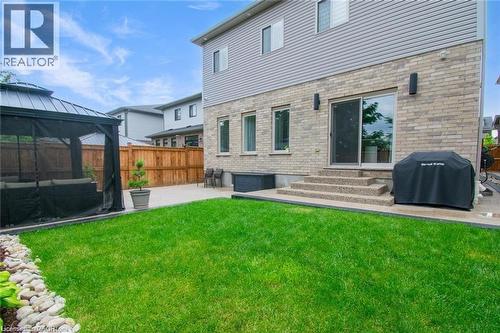 Back of property with a patio area, a gazebo, a fenced backyard, and brick siding - 49 Scots Pine Trail, Kitchener, ON - Outdoor