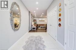 Corridor with light tile patterned floors and recessed lighting - 