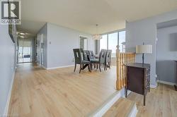 Dining area featuring light wood-style flooring, a chandelier, and a textured ceiling - 